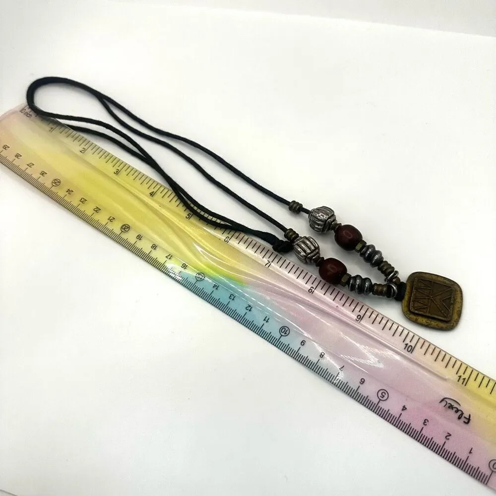 Baer SF sterling silver and brass pendant necklace on black cord